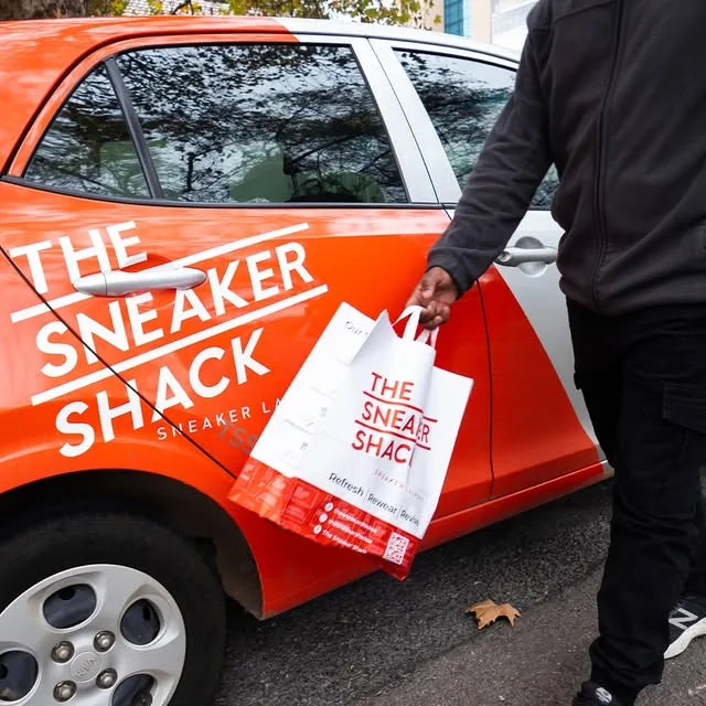 The Sneaker Shack branded delivery car collecting a restoration order