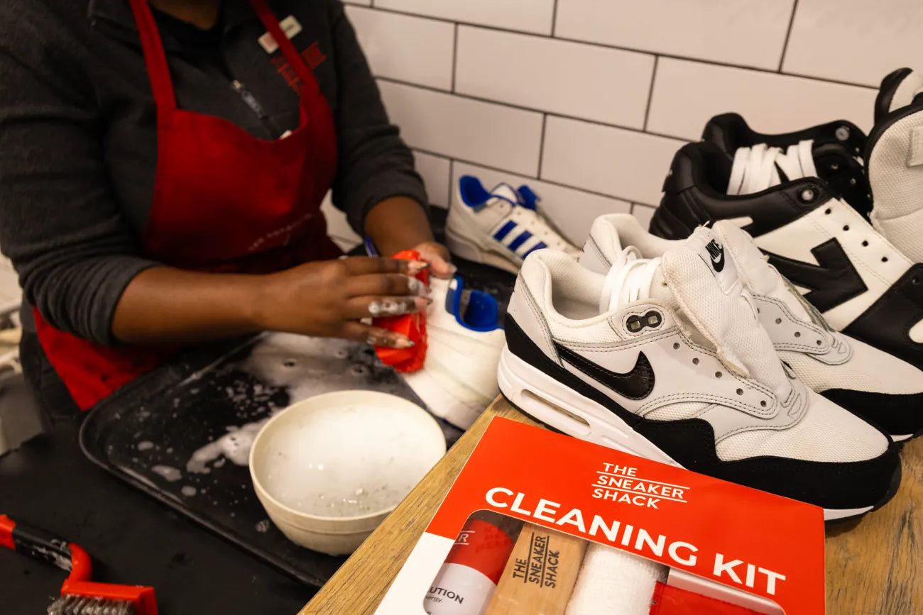 A Sneaker Shack technician restoring a sneaker by hand